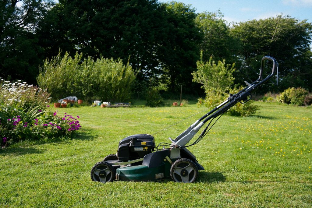 A lawn mower sitting on a beautiful San Diego lawn.