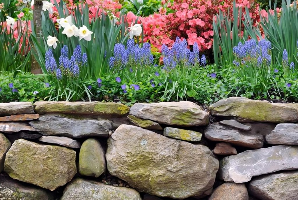 A beautiful rockscape ledge with a flowerbed above it.