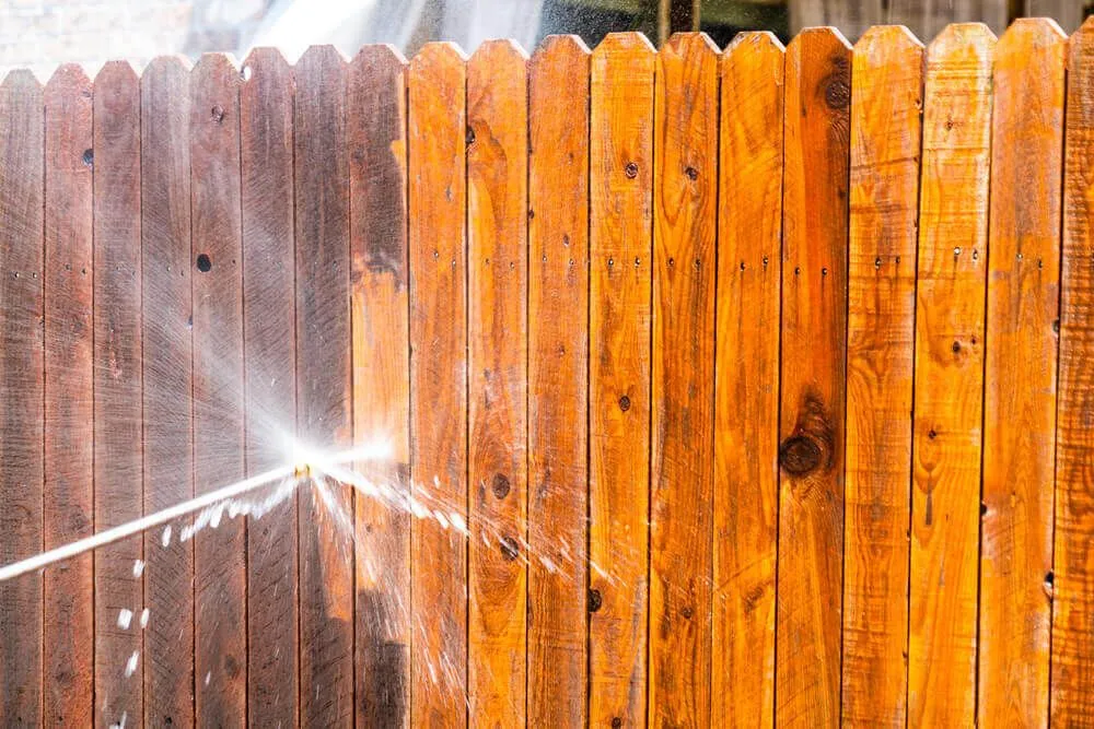 Power washing a wooden fence